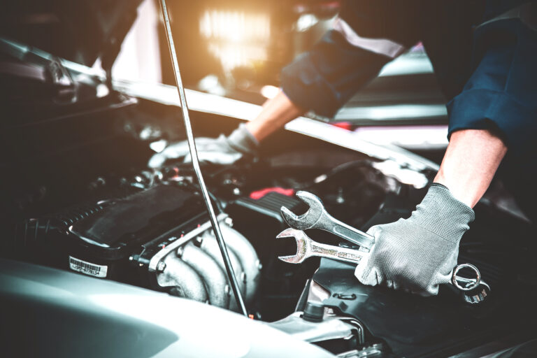 Close-up hand technician holding the wrench to repairing car